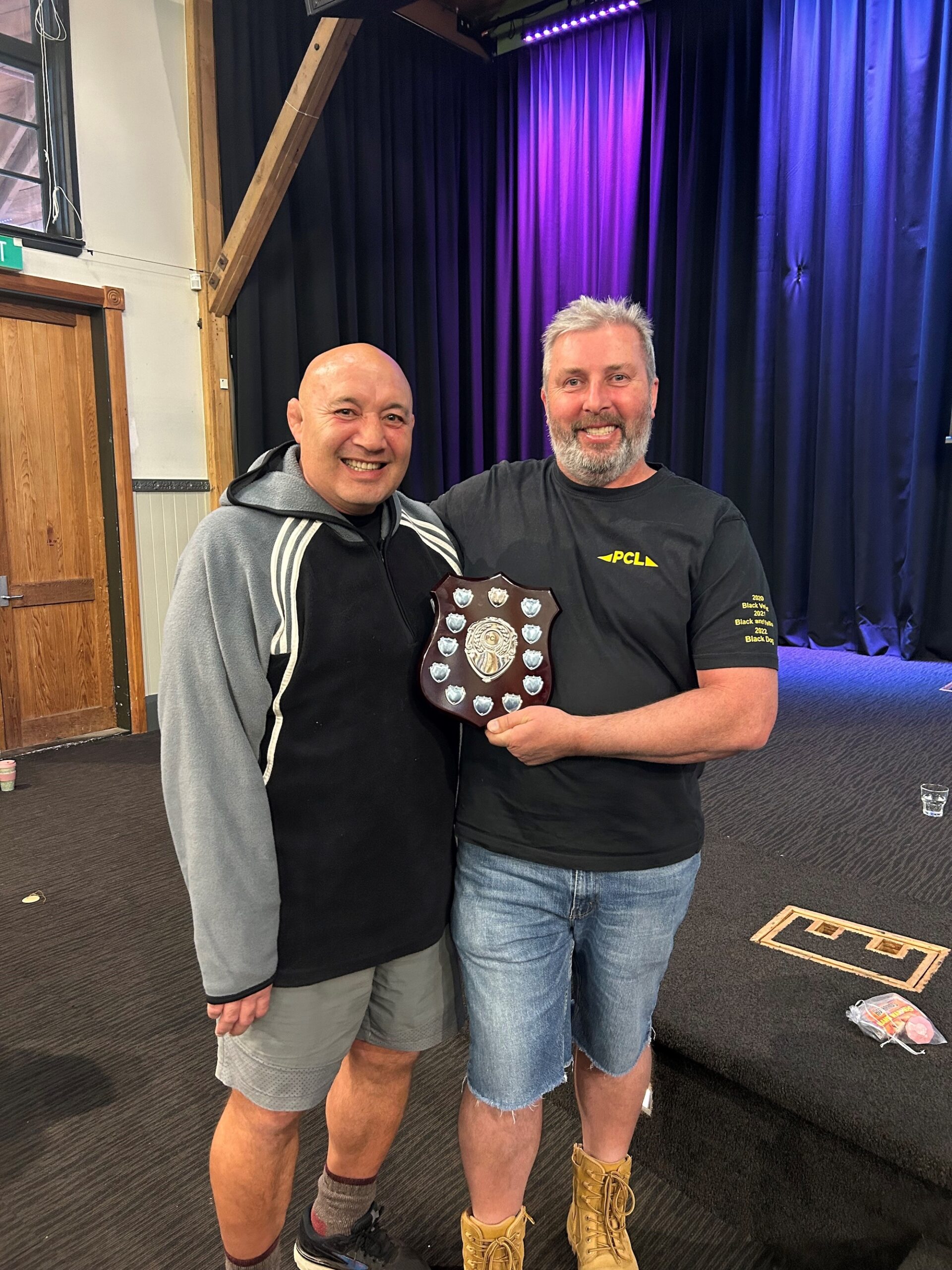 Norm Hewitt and Luke Lee standing holding an award.